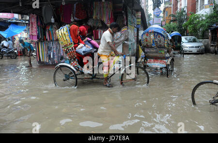 Dhaka, Bangladesh. 19th Jun, 2017.  Rickshaw pullers try to driving through a flooded street in Dhaka, Bangladesh, June 19, 2017. Encroachment of canals is contributing to the continual water logging in the Capital Dhaka. Credit: SK Hasan Ali/Alamy Live News Stock Photo