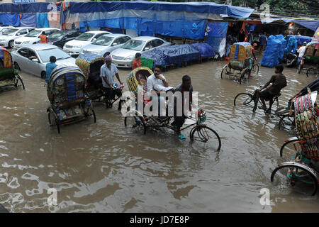 Dhaka, Bangladesh. 19th Jun, 2017.  Rickshaw pullers try to driving through a flooded street in Dhaka, Bangladesh, June 19, 2017. Encroachment of canals is contributing to the continual water logging in the Capital Dhaka. Credit: SK Hasan Ali/Alamy Live News Stock Photo