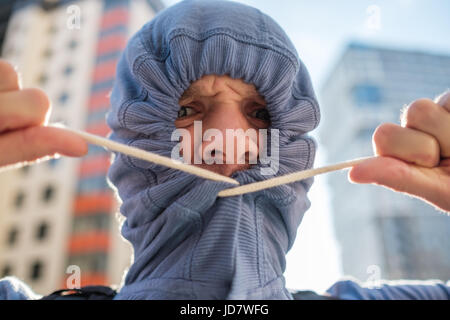 Caucasianyoung man hiding unshaven face with hood. Secrecy and mystery. Sociopathy and fear of going out. Stock Photo