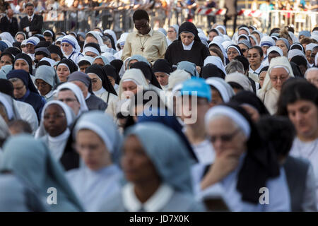 Rome, Italy. 18th June, 2017. Nuns attend a Holy Mass celebrated by Pope Francis at St. John Lateran Basilica to mark the Solemnity of Corpus Domini or Corpus Christi in Rome, Italy on June 18, 2017. The Roman Catholic feast of Corpus Domini, commemorates Christ's last supper and the institution of the Eucharist. The mass was followed by the traditional torchlight procession, in which parish groups, sodalities and charitable and fraternal organisations of all kinds participate along with ordinary citizens, from the St. John Lateran Basilica to the St. Mary Major Basilica. (Photo by Giuseppe Ci Stock Photo