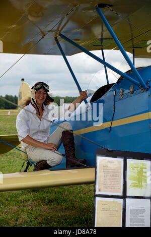 Female pilot re-enactor on a 1930 Bird BK,  This plane was originally owned by Anne Morrow Lindbergh, wife of famed aviator Charles Lindbergh. Stock Photo