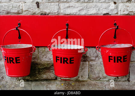 Three bright red fire buckets Stock Photo