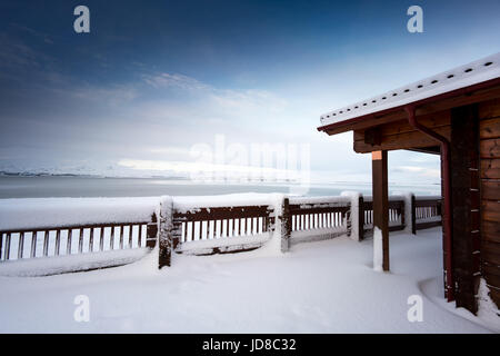 Log cabin and fence in snow covered landscape, Iceland, Europe. Iceland nature 2017 winter cold Stock Photo