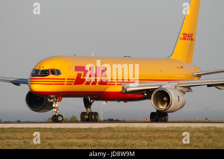 Air transport. DHL Boeing 757-200F cargo jet aeroplane lining up for takeoff from Malta. Global freight delivery route networks. Stock Photo