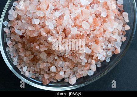 Pink Himalayan sea salt on a dark background. Stock Photo