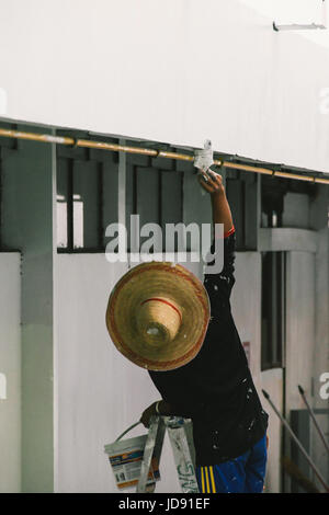Construction working putting plaster on a wall Stock Photo