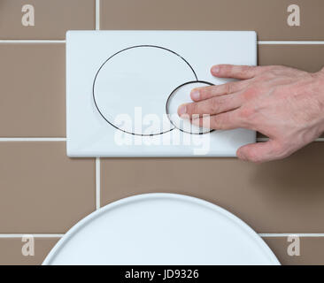 Economic toilet flush press with two separate buttons Stock Photo