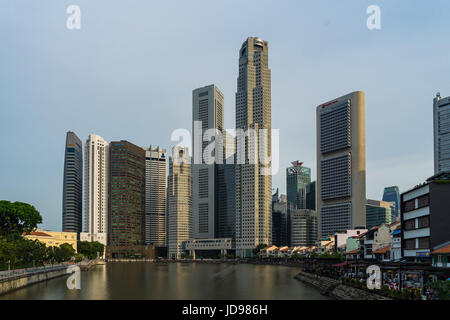 Singapore - April 29, 2017: Boat Quay, a historical district in Singapore and Financial building in background Stock Photo