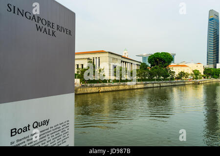 Singapore - April 29, 2017: Boat Quay, a historical district in Singapore with tall skyscrapers the central business district in background Stock Photo