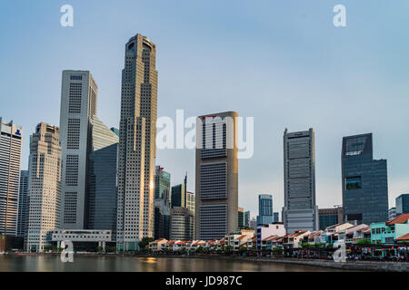 Singapore - April 29, 2017: Boat Quay, a historical district in Singapore and Financial building in background Stock Photo