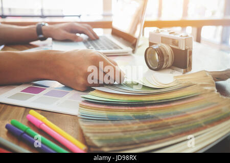 Graphic design and color swatches and pens on a desk. Architectural drawing with work tools and accessories. Stock Photo