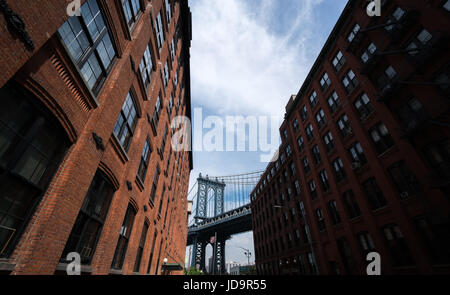 Low angle view of Manhattan Bridge seen through buildings, New York City, USA. 2016 urban city United States of America Stock Photo