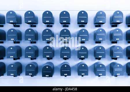 Mailboxes in residential for informations and news with room number, toned in blue. Stock Photo