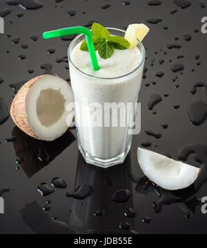 Milkshake with coconut on a black background with drops of water Stock Photo