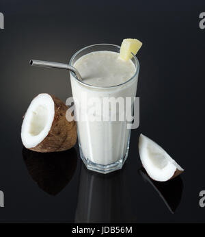 Milkshake with coconut and pineapple on a black background Stock Photo