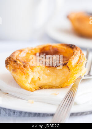 Portuguese cuisine: pastel de nata, a traditional custard tart pastry, close up. Stock Photo