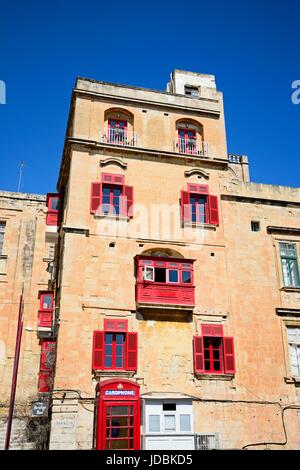 The Bridge bar building along Liesse with a red British telephone box in the foreground, Valletta, Malta, Europe. Stock Photo