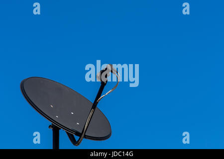 Consumer KU band satellite dish on rooftop. Stock Photo