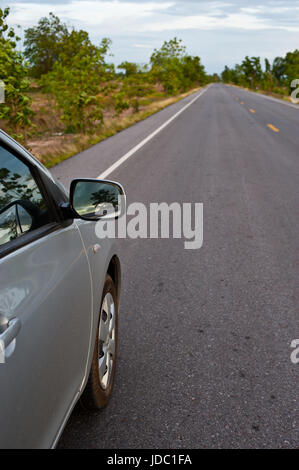 Rear side perspective view of car on road countryside Stock Photo - Alamy