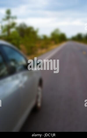 Rear side perspective view of car on road countryside Stock Photo - Alamy