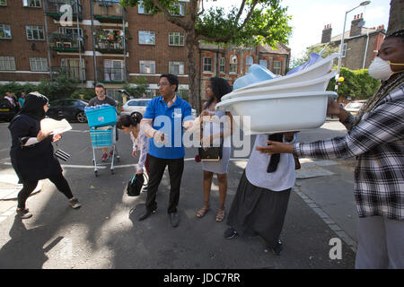 Local community dispensing food and clothes to help aid the victims left homeless after the Grenfell Tower fire disaster, West London, UK Stock Photo