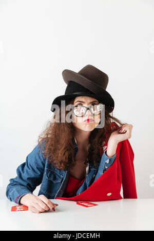 Funny thoughtful shopaholic woman wearing sale signs isolated over white Stock Photo