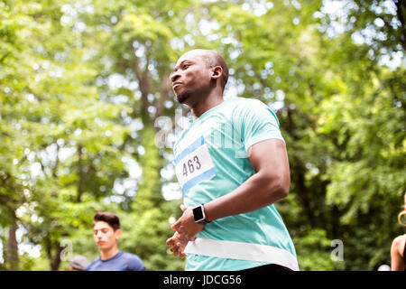 Young fit afro-american man crossing the finish line. Stock Photo