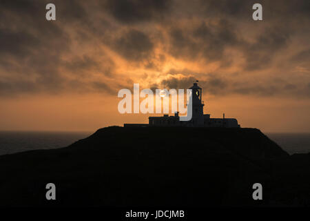 Sunset sky at Strumble Head lighthouse, Pencaer Peninsula, Pembrokeshire Coast National Park, Wales, UK Stock Photo