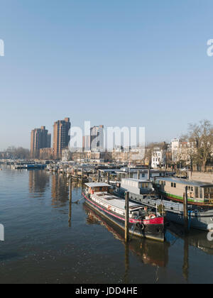 Houseboats at Chelsea with the tower block of the World’s End estate in the background, London, England,UK Stock Photo