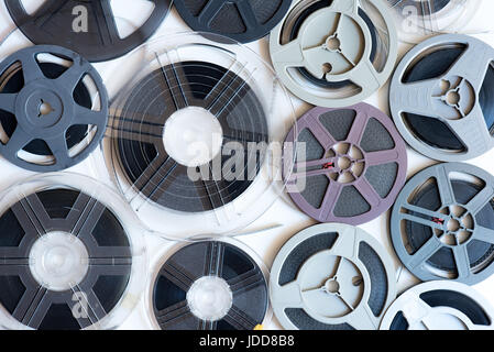 Background of many different aged vintage super 8 mm movie reels on white surface background Stock Photo