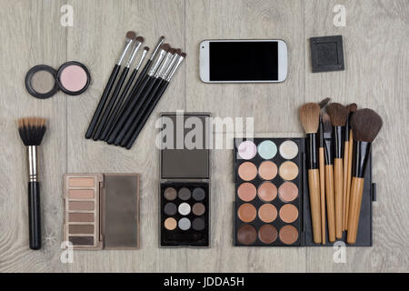 Objects for makeup. Overhead view of makeup accessories. Different objects on wooden background. Stock Photo