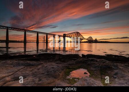 Edinburgh, Scotland, UK. 20th June, 2017. A spectacular sunset over the Forth Bridges in South Queensferry near Edinburgh Credit: Rich Dyson/Alamy Live News Stock Photo