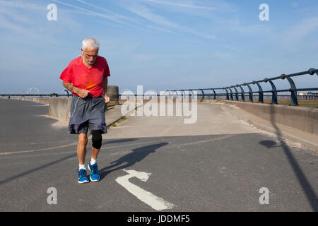 Elderly athletes at Southport, Merseyside, UK.   UK Weather. 20th June, 2017. Jack Dodd 83 years old taking his early morning run. Bright sunny start to the day as local residents enjoy the sunny morning on the promenade and the extensive views across the sands of the resort, the Victorian Pier and the Irish Sea. As the heatwave continues temperatures are expected to reach 30C in the afternoon. Stock Photo