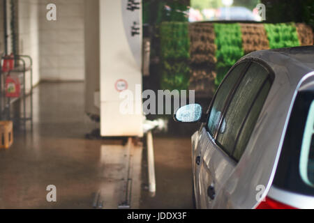 Clean silver colored automobile in car wash service interior Stock Photo
