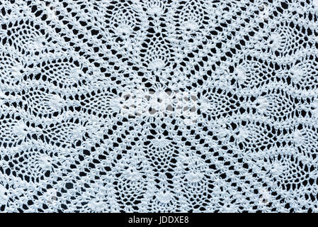 White crochet fabric on black as background and texture Stock Photo