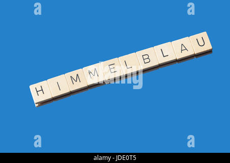 Letter tiles on blue Background showing the word Himmelblau Stock Photo