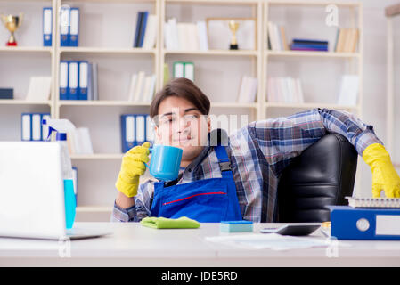 Male cleaner working in the office Stock Photo