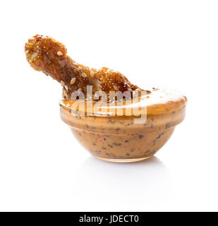 Fried chicken wings in sauce on white isolated background Stock Photo