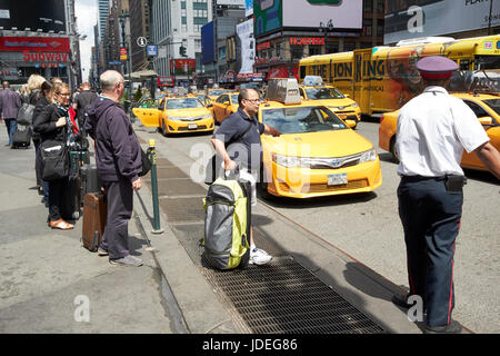 people waiting at yellow cabs stop at taxi rank on 7th avenue outside penn station New York City USA Stock Photo