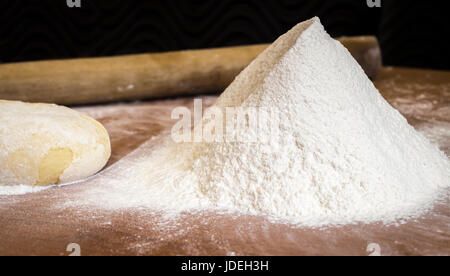 Sifted flour on the kitchen table closeup Stock Photo