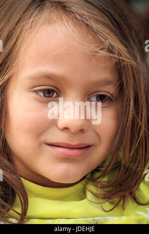 A close up shot of a child's face with messy hair Stock Photo