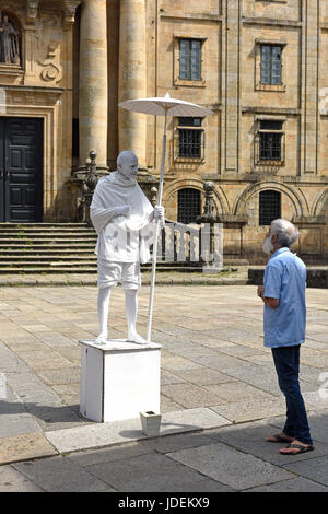 Man talking to mime artist dressed as Mahatma Gandhi in Santiago de Compostela in Northern Spain Stock Photo