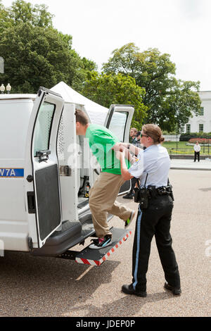 Police detained environmental protester led into police van - Washington, DC USA