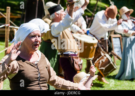 Medieval Rough Musicke living history minstrel group performing on the Green, Sandwich town. Row of musicians dressed in medieval costumes. Stock Photo