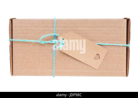 Cardboard gift box tied with blue string. Blank label on it. Isolated on white, clipping path included Stock Photo