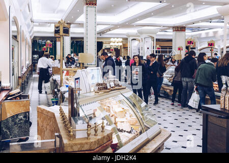 London, England - April 4, 2017: Harrods department store interior, food area with people on April 4, 2017 in London, UK. Harrods is the biggest depar Stock Photo