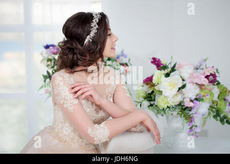 Portrait of a beautiful girl in a wedding dress. Bride with beautiful decoration in her hair Stock Photo