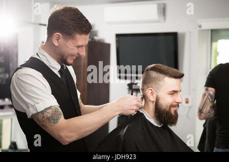 Professional barber doing a haircut Stock Photo