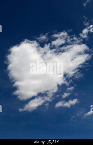 Heart-shaped cloud in the sky of Alberta, Canada. The cloud is in blue sky. Stock Photo