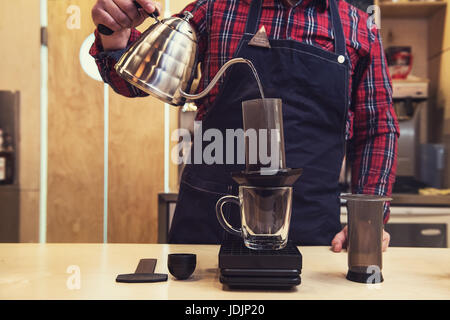 Barista brewing aeropress coffee Stock Photo
